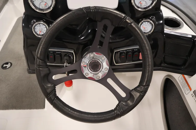 Slide: The Image of Steering wheel and dashboard of 2019 Nitro Z19 Sport boat with gauges and controls. - 22