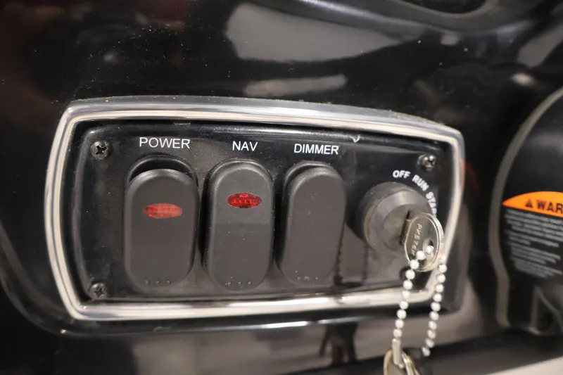 Slide: The Image of Control panel of a 2019 Nitro Z19 Sport boat with switches and ignition key. - 27
