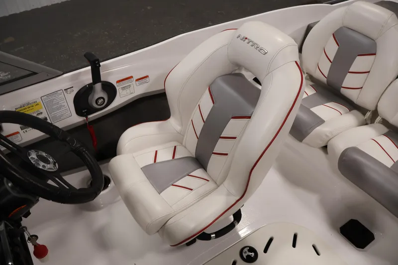 Slide: The Image of 2019 Nitro Z19 Sport boat interior with white and gray seating, steering wheel, and controls. - 31