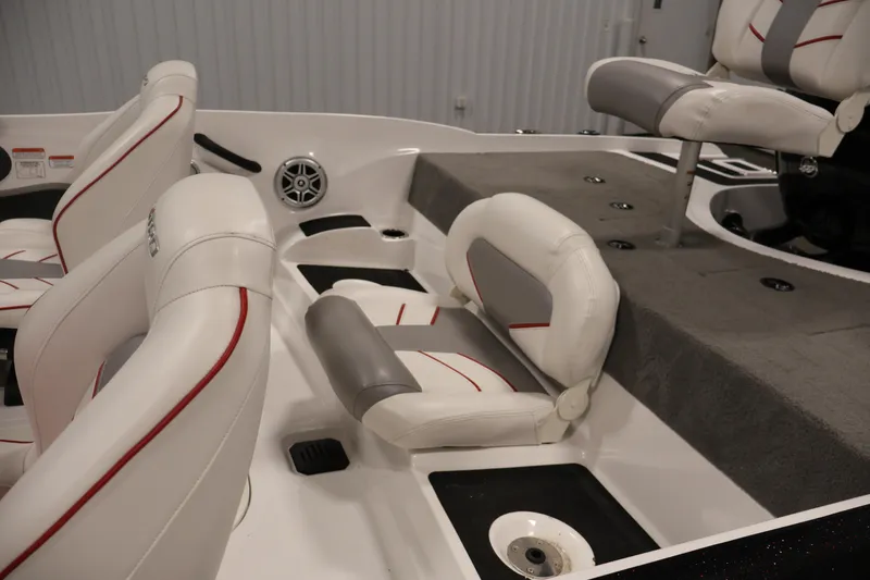 Slide: The Image of 2019 Nitro Z19 Sport boat interior with white and gray seating, red accents. - 40