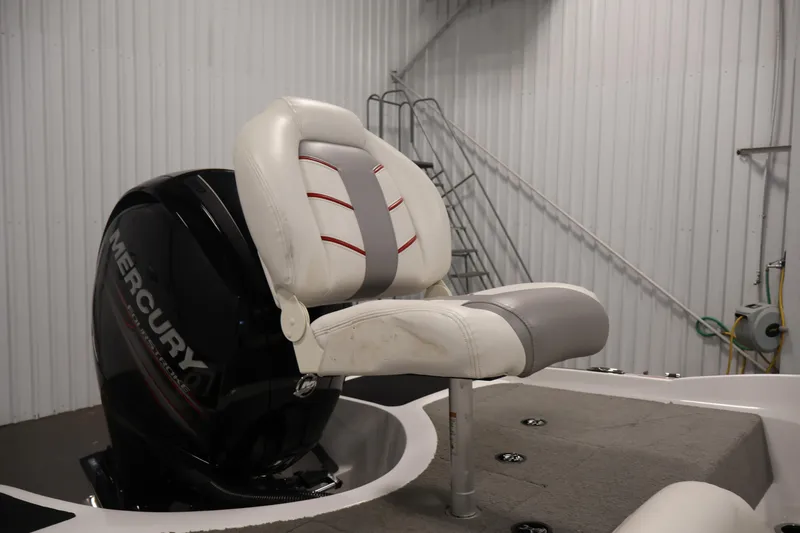 Slide: The Image of 2019 Nitro Z19 Sport boat seat with Mercury engine in a garage setting. - 43