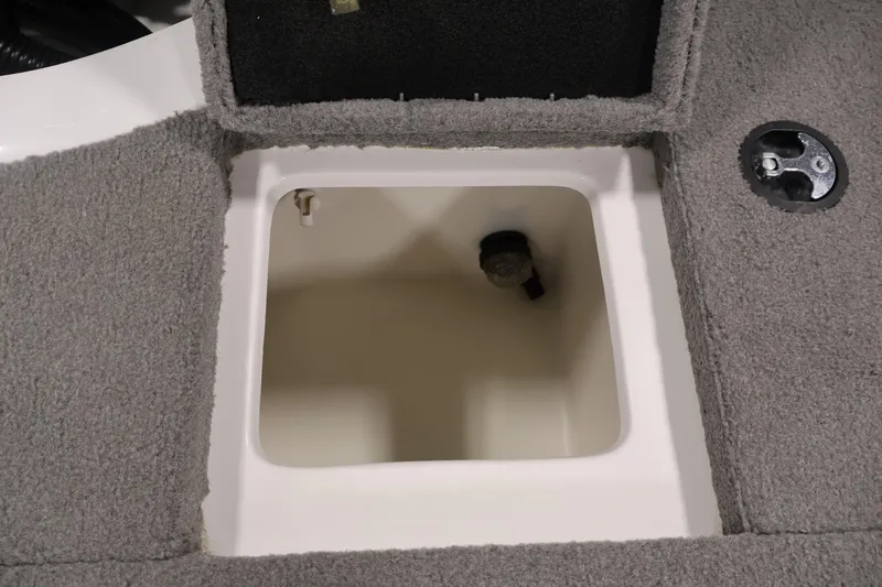 Slide: The Image of Open storage compartment in 2019 Nitro Z19 Sport boat, featuring gray carpeted interior. - 48