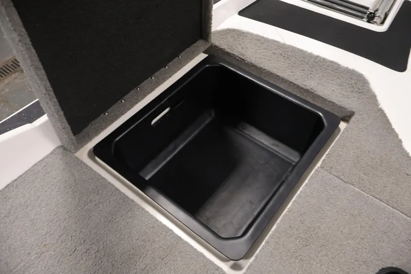 Slide: The Image of Open storage compartment in 2019 Nitro Z19 Sport boat, featuring carpeted interior. - 50