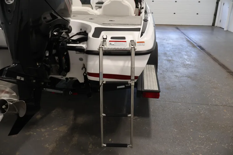 Slide: The Image of 2019 Nitro Z19 Sport boat with ladder and motor in a garage setting. - 52
