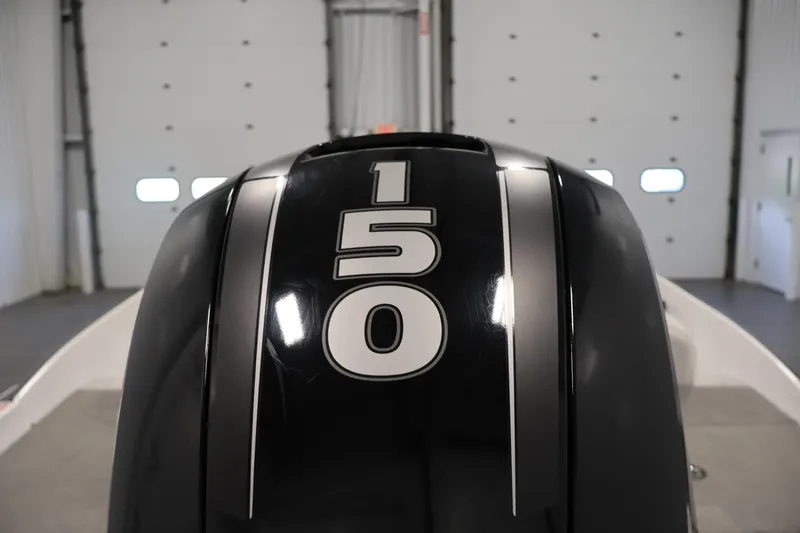 Slide: The Image of 2019 Nitro Z19 Sport boat engine with "150" horsepower label in a garage setting. - 55