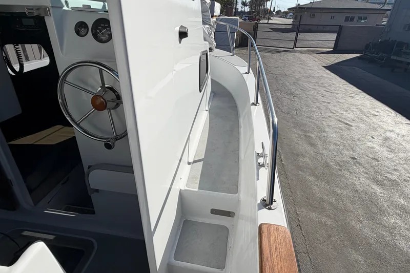 Slide: The Image of 1986 Radon 21 Sport boat interior with steering wheel and deck view. - 11