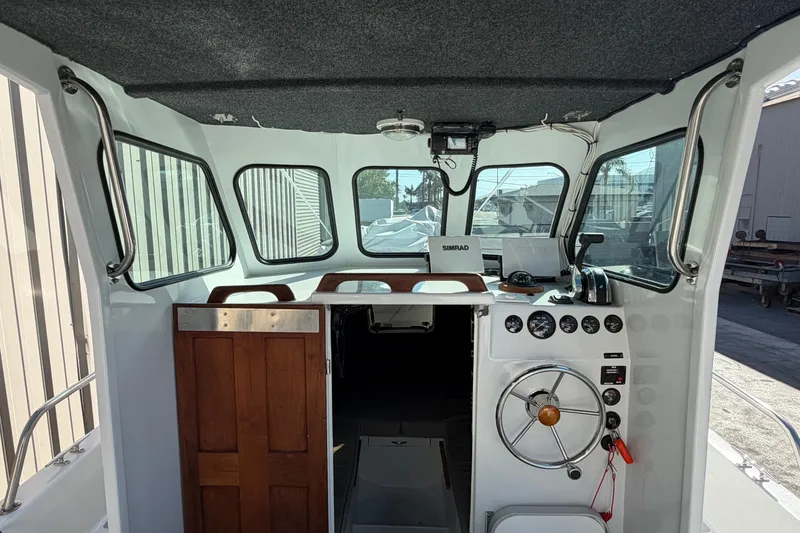 Slide: The Image of Interior of a 1986 Radon 21 Sport boat with steering wheel and control panel. - 12