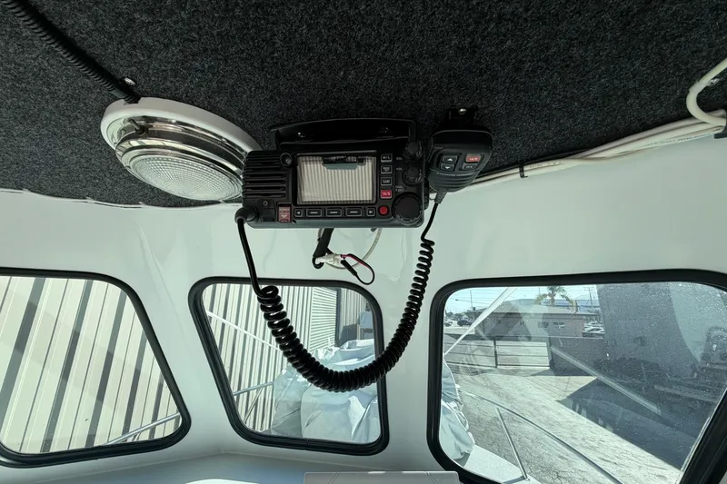 Slide: The Image of Interior of a 1986 Radon 21 Sport boat with radio equipment and windows. - 16