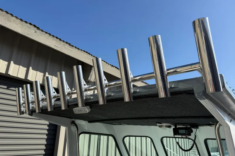 Slide: The Image of Stainless steel rod holders on 1986 Radon 21 Sport boat under clear blue sky. - 18
