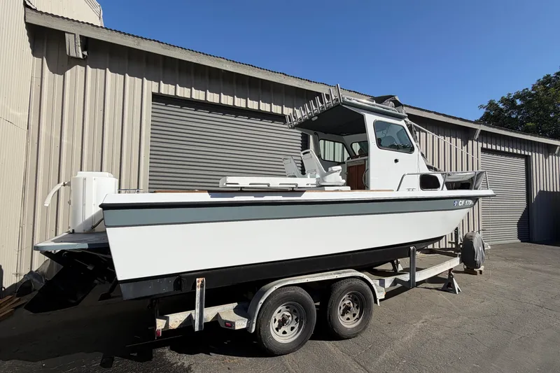 Slide: The Image of 1986 Radon 21 Sport boat on trailer, parked outside a warehouse. - 2