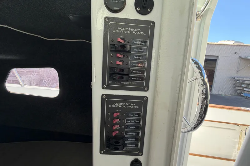 Slide: The Image of Accessory control panels inside a 1986 Radon 21 Sport boat, featuring various switches. - 20