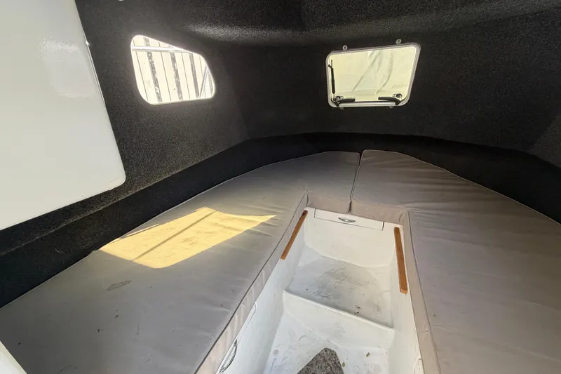 Slide: The Image of Interior cabin of a 1986 Radon 21 Sport boat with cushioned seating. - 22