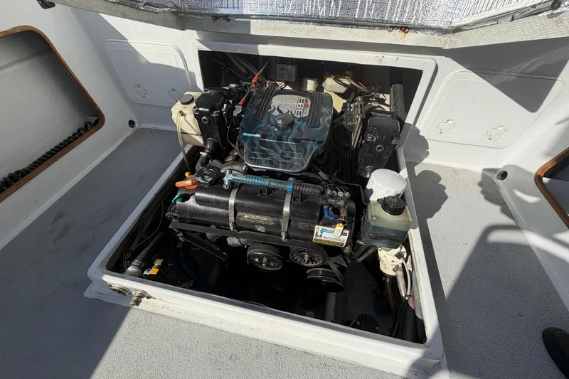 Slide: The Image of Engine compartment of a 1986 Radon 21 Sport boat, showcasing detailed mechanical components. - 25