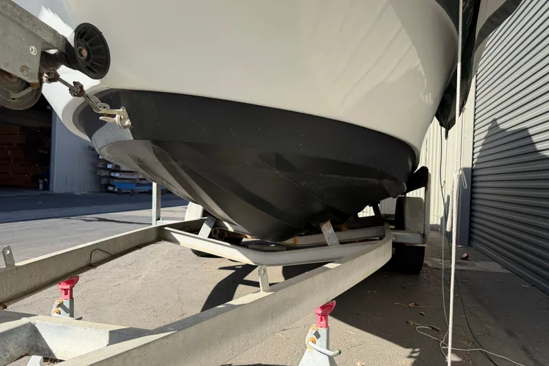Slide: The Image of 1986 Radon 21 Sport boat on trailer, showing hull and bow details in a garage setting. - 27