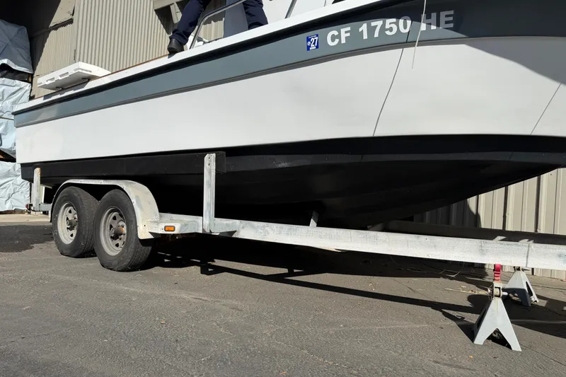 Slide: The Image of 1986 Radon 21 Sport boat on trailer, parked outdoors near a building. - 28