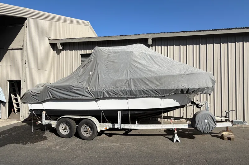 Slide: The Image of Covered 1986 Radon 21 Sport boat on trailer beside industrial building. - 3
