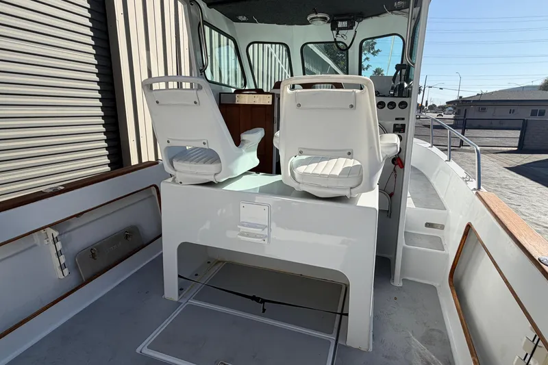 Slide: The Image of 1986 Radon 21 Sport boat interior with white seating and control panel. - 6
