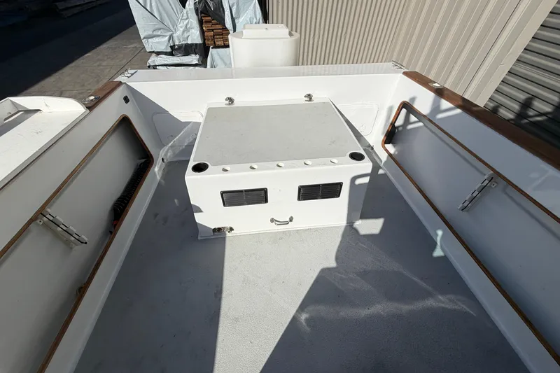 Slide: The Image of 1986 Radon 21 Sport boat deck with storage compartment and wooden railings. - 8