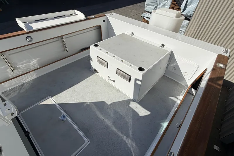 Slide: The Image of 1986 Radon 21 Sport boat deck with storage compartment and wooden trim. - 9