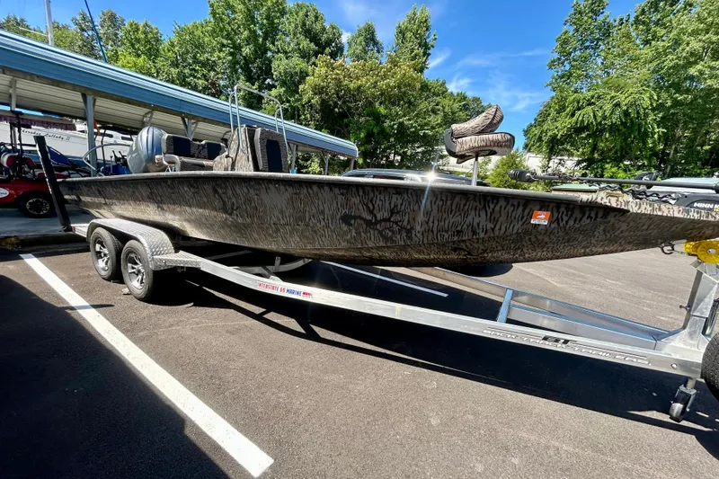 Slide: The Image of 2025 Xpress H22B Bay boat on trailer, parked outdoors under clear blue sky. - 19