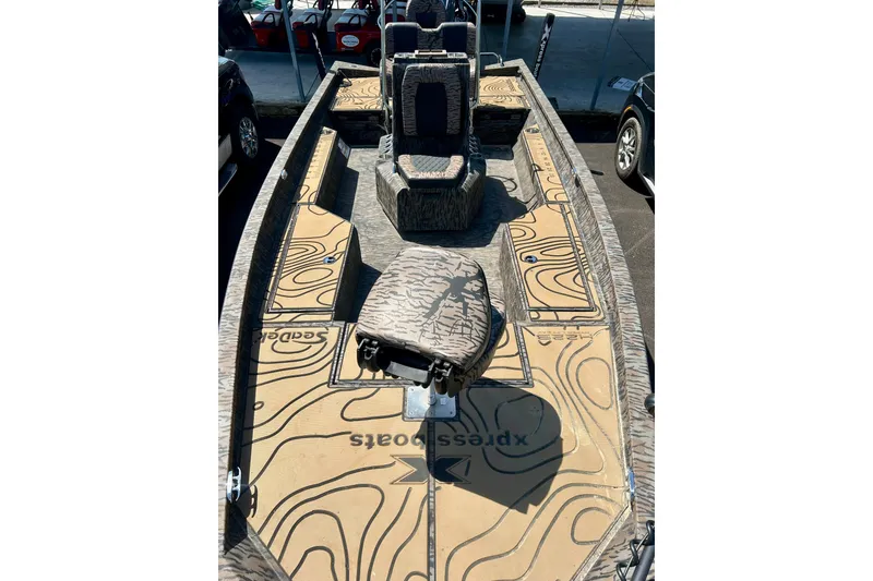 Slide: The Image of 2025 Xpress H22B Bay boat interior with camouflage design and spacious seating. - 29