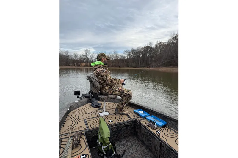 Slide: The Image of Person fishing on a 2025 Xpress H22B Bay boat in a serene lake setting. - 3