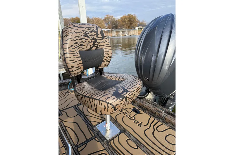 Slide: The Image of Tiger-striped boat seat on 2025 Xpress H22B Bay, near water. - 5