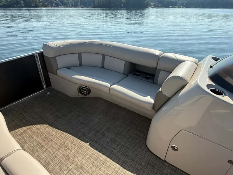 Slide: The Image of Interior of a 2021 Harris Cruiser 230 pontoon boat on calm water. - 10