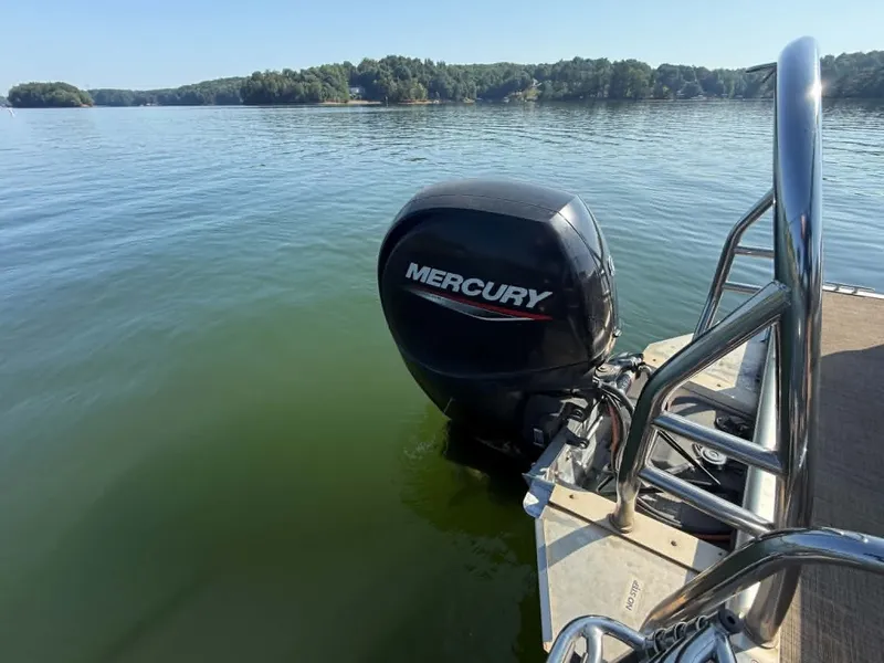 Slide: The Image of Harris Cruiser 230 boat with Mercury engine on calm water. - 11