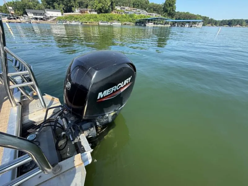 Slide: The Image of 2021 Harris Cruiser 230 with Mercury engine on the water. - 13
