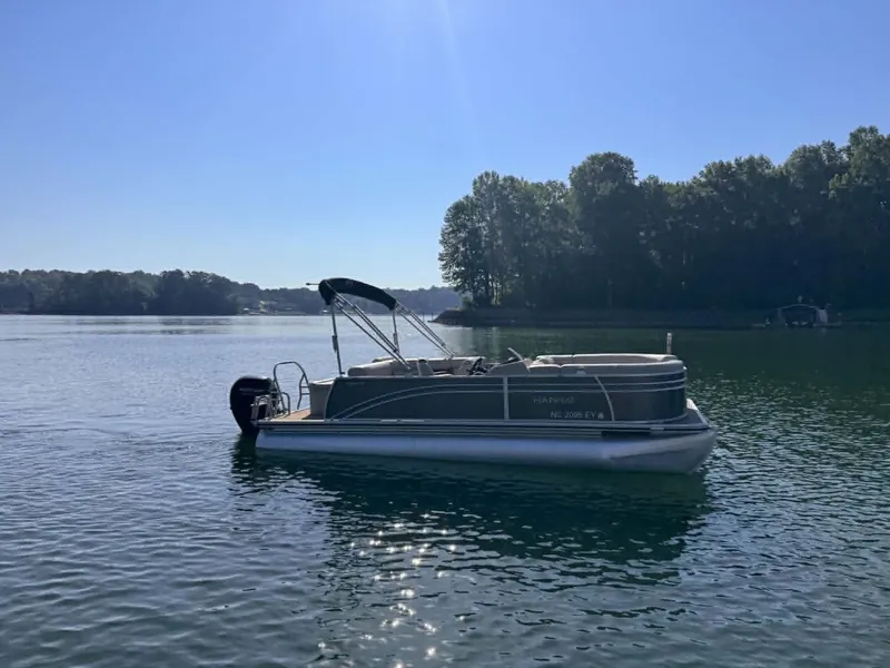 Slide: The Image of Harris Cruiser 230 pontoon boat 2021 on calm lake. - 14