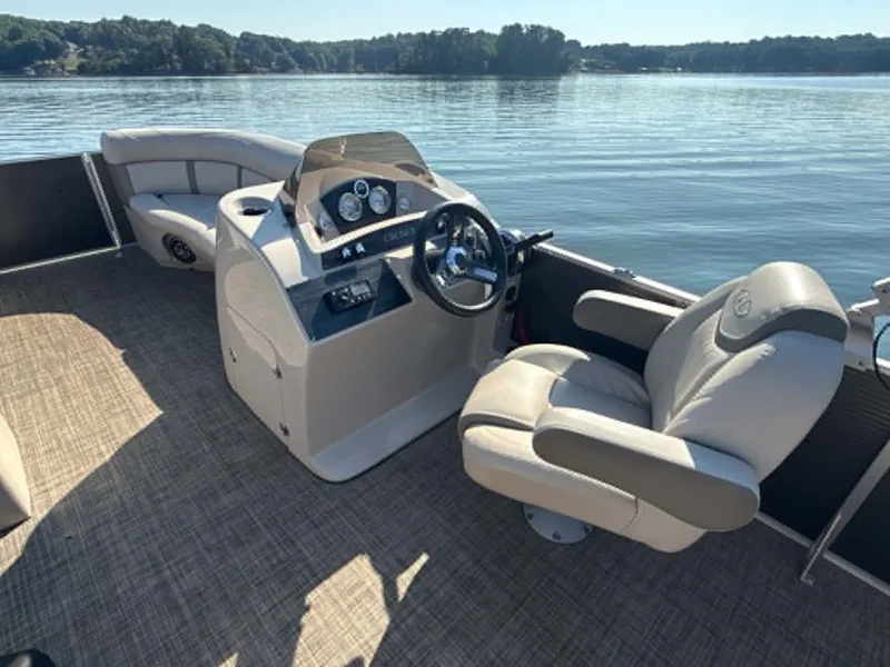 Slide: The Image of Interior of a Harris Cruiser 230 pontoon boat on a lake. - 16