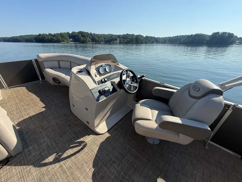 Slide: The Image of 2021 Harris Cruiser 230 pontoon boat on serene lake. - 19