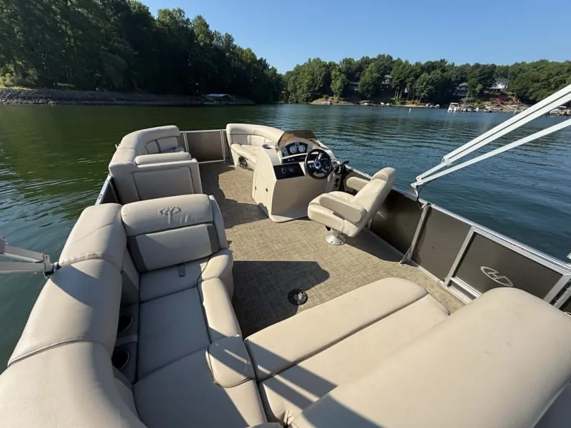 Slide: The Image of 2021 Harris Cruiser 230 pontoon boat on calm lake. - 4