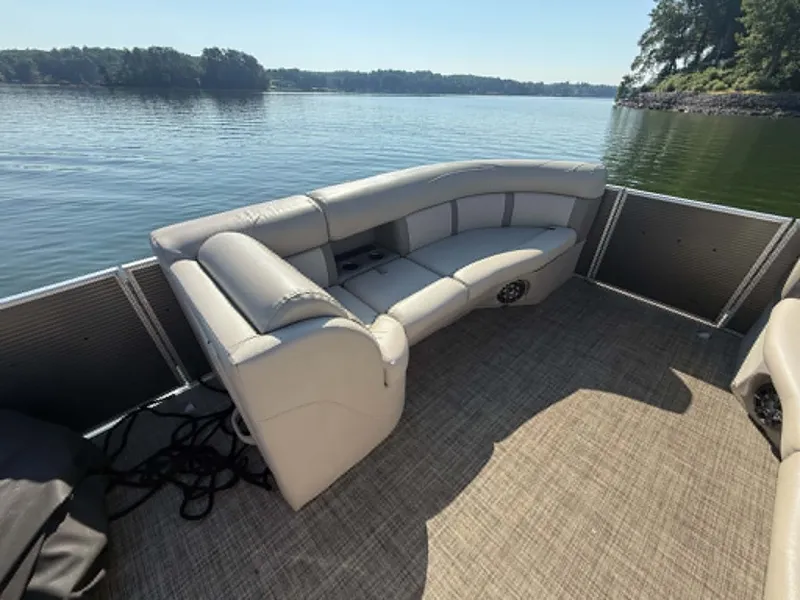 Slide: The Image of 2021 Harris Cruiser 230 pontoon boat on calm water. - 5