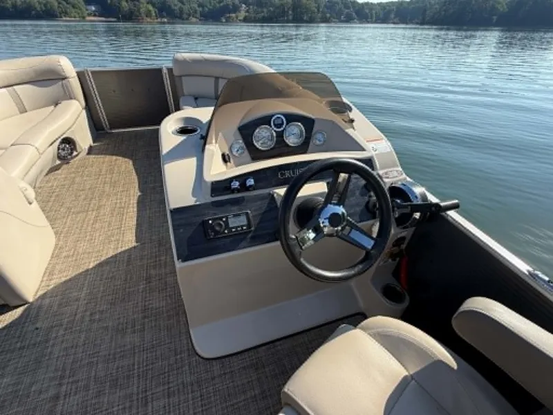 Slide: The Image of Interior view of a Harris Cruiser 230 pontoon boat on the water. - 6