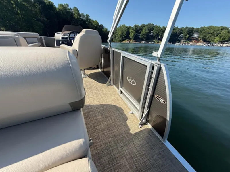 Slide: The Image of Harris Cruiser 230 pontoon boat on a calm lake, year 2021. - 8