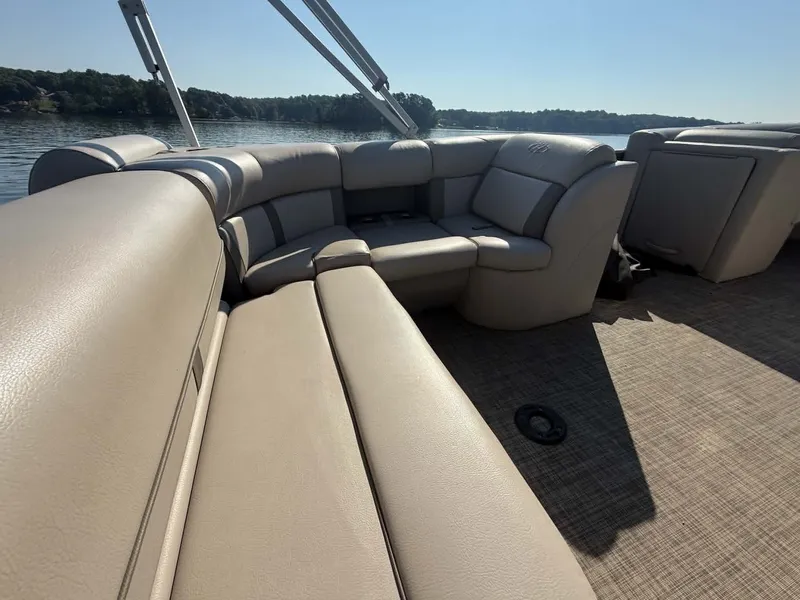 Slide: The Image of Interior of a 2021 Harris Cruiser 230 pontoon boat on a calm lake. - 9
