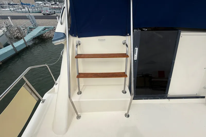 Slide: The Image of Stairs on 1986 Sea Ray 410 Aft Cabin yacht, leading to upper deck. - 15