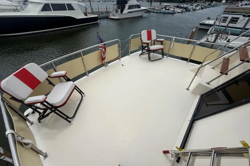 Slide: The Image of 1986 Sea Ray 410 Aft Cabin deck with chairs, overlooking marina. - 16