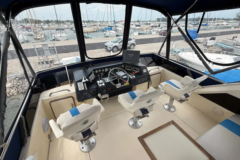 Slide: The Image of Cockpit of 1986 Sea Ray 410 Aft Cabin yacht with marina view. - 18