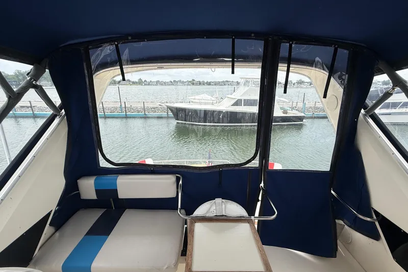 Slide: The Image of Interior view of 1986 Sea Ray 410 Aft Cabin yacht with marina backdrop. - 20