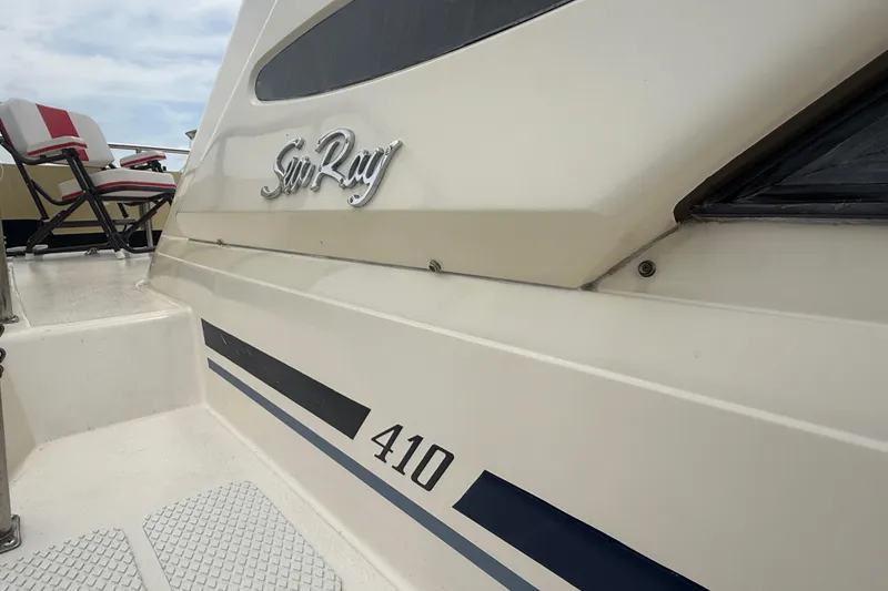 Slide: The Image of 1986 Sea Ray 410 Aft Cabin boat with logo and seating area. - 6