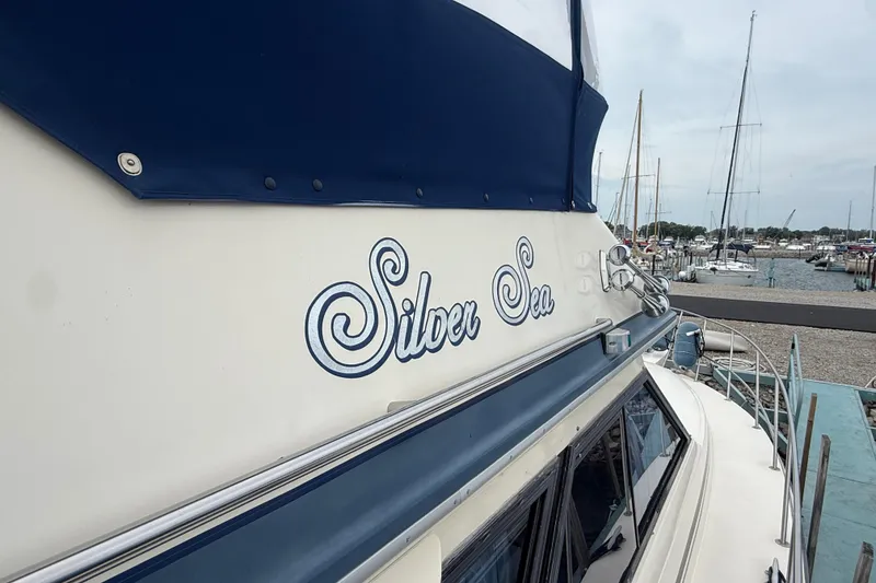 Slide: The Image of 1986 Sea Ray 410 Aft Cabin yacht named "Silver Sea" docked at a marina. - 7