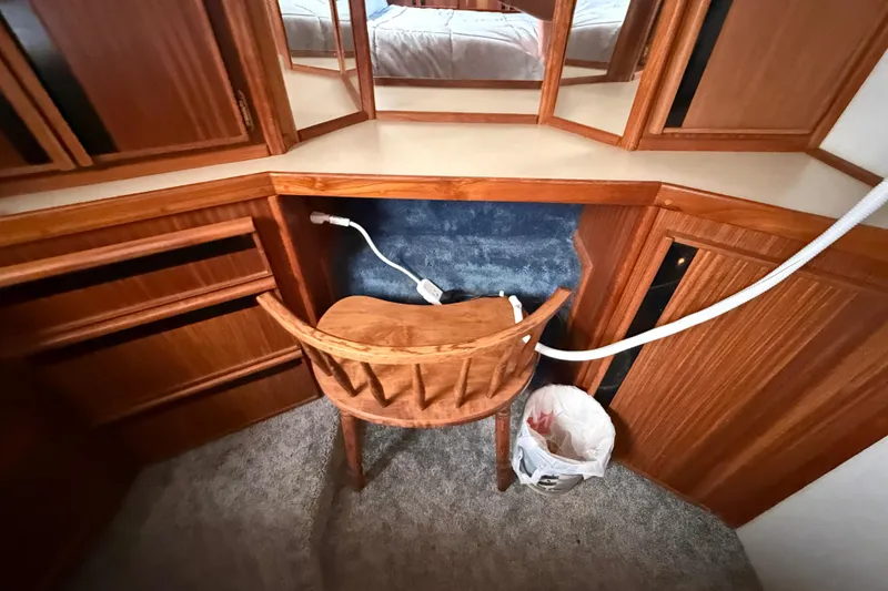 Slide: The Image of 1986 Sea Ray 410 Aft Cabin interior with wooden desk and chair. - 70