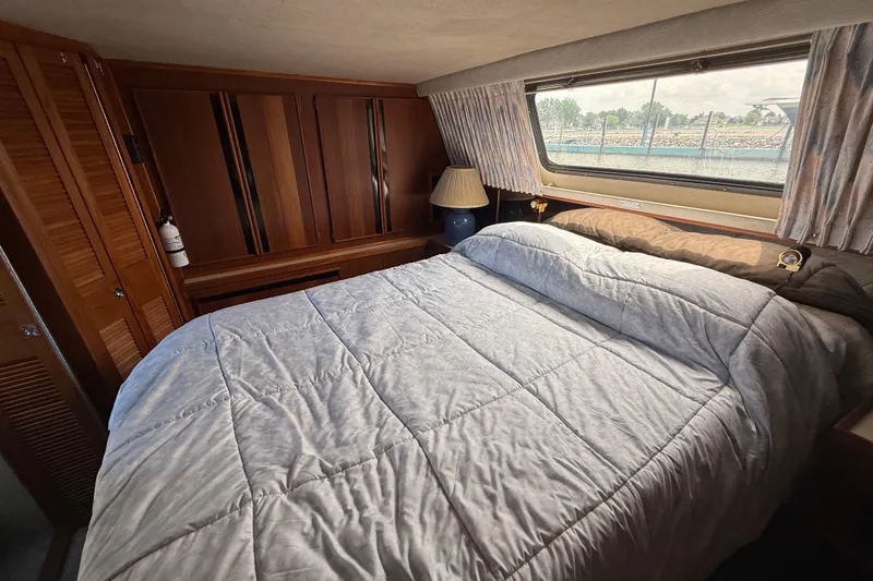 Slide: The Image of Cozy bedroom in 1986 Sea Ray 410 Aft Cabin yacht with window view. - 73