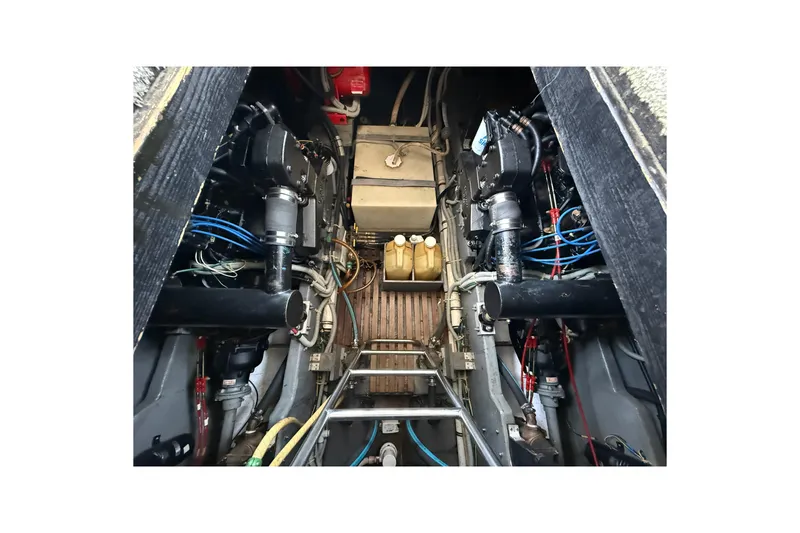 Slide: The Image of Engine room of 1986 Sea Ray 410 Aft Cabin boat, showcasing mechanical components. - 77