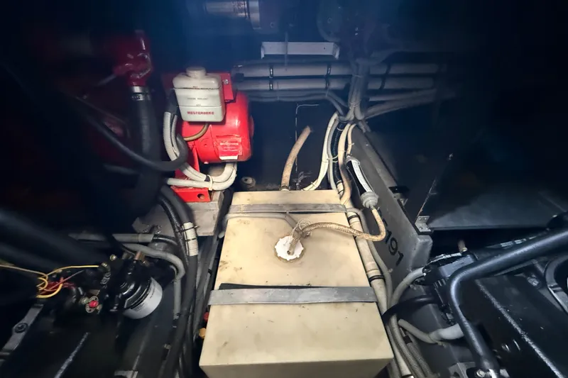 Slide: The Image of Engine room of a 1986 Sea Ray 410 Aft Cabin with visible wiring and components. - 80
