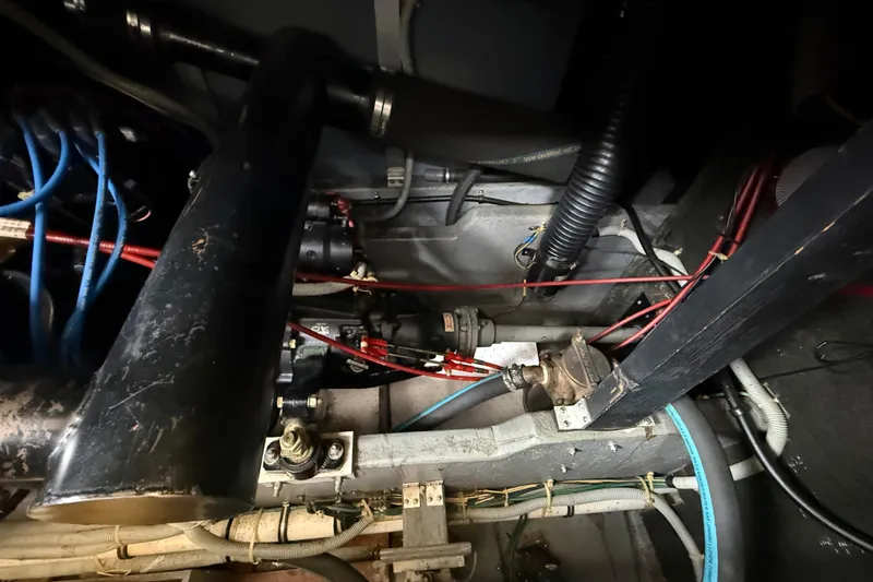 Slide: The Image of Engine room of 1986 Sea Ray 410 Aft Cabin with visible wiring and components. - 82