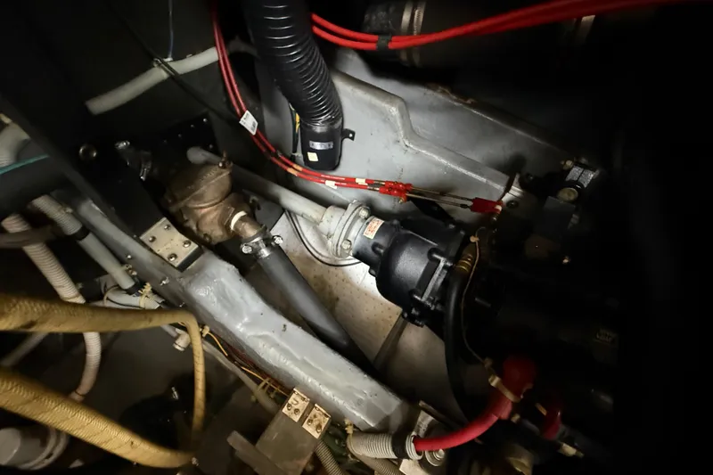 Slide: The Image of Engine room of 1986 Sea Ray 410 Aft Cabin with visible mechanical components. - 84